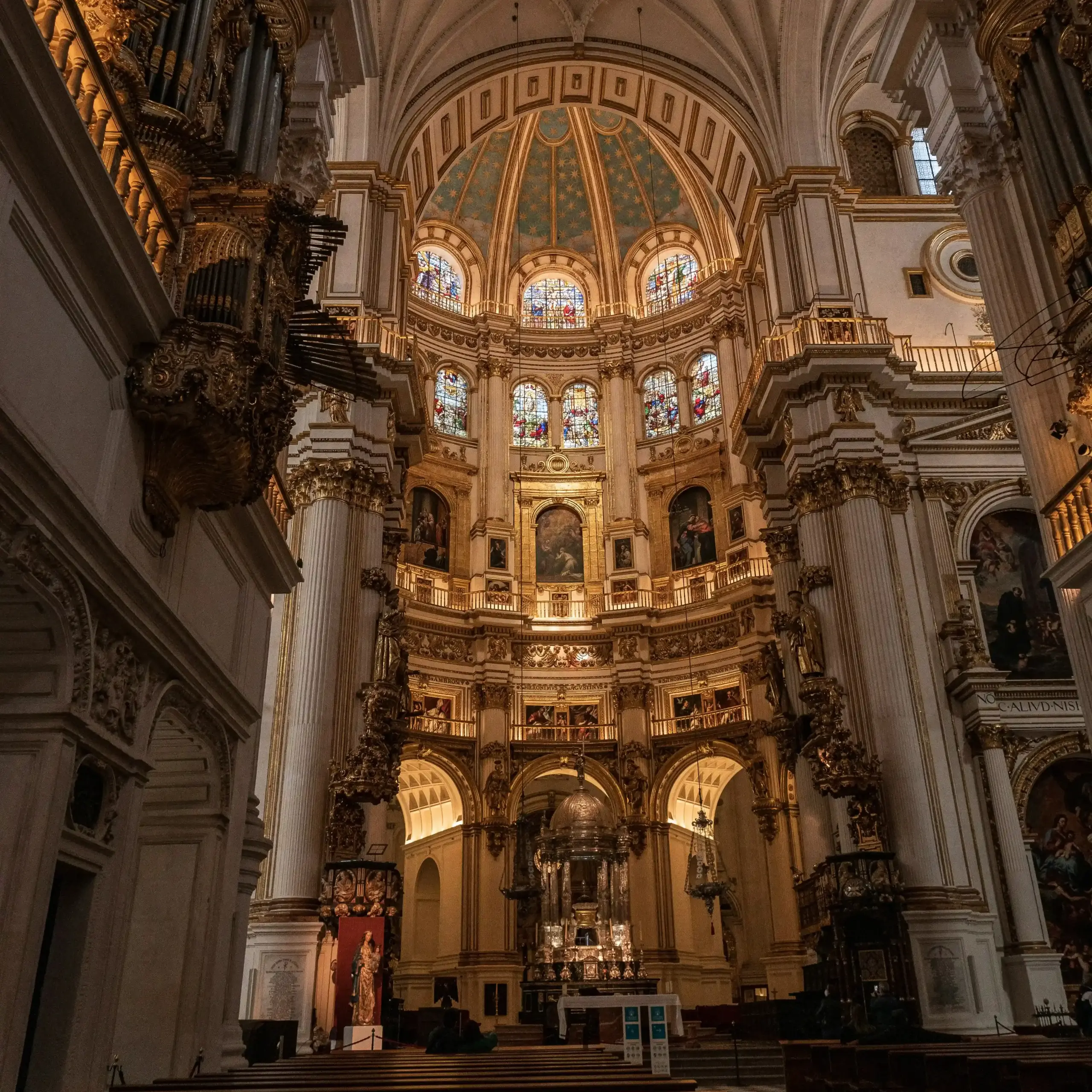Interno della Catedral de Granada con grande cupola, colonne monumentali e altare centrale