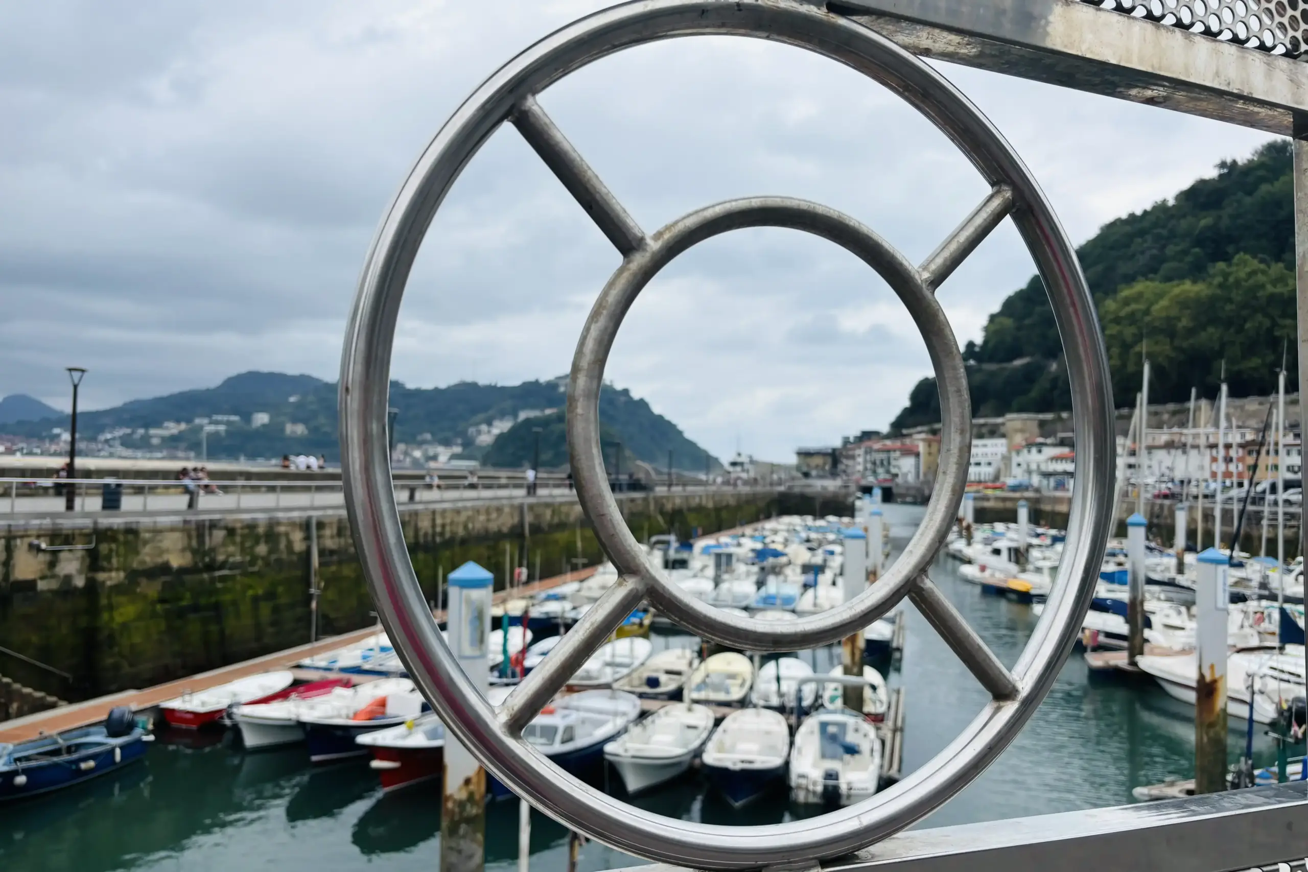 Porto di San Sebastián visto attraverso la ringhiera metallica del lungomare